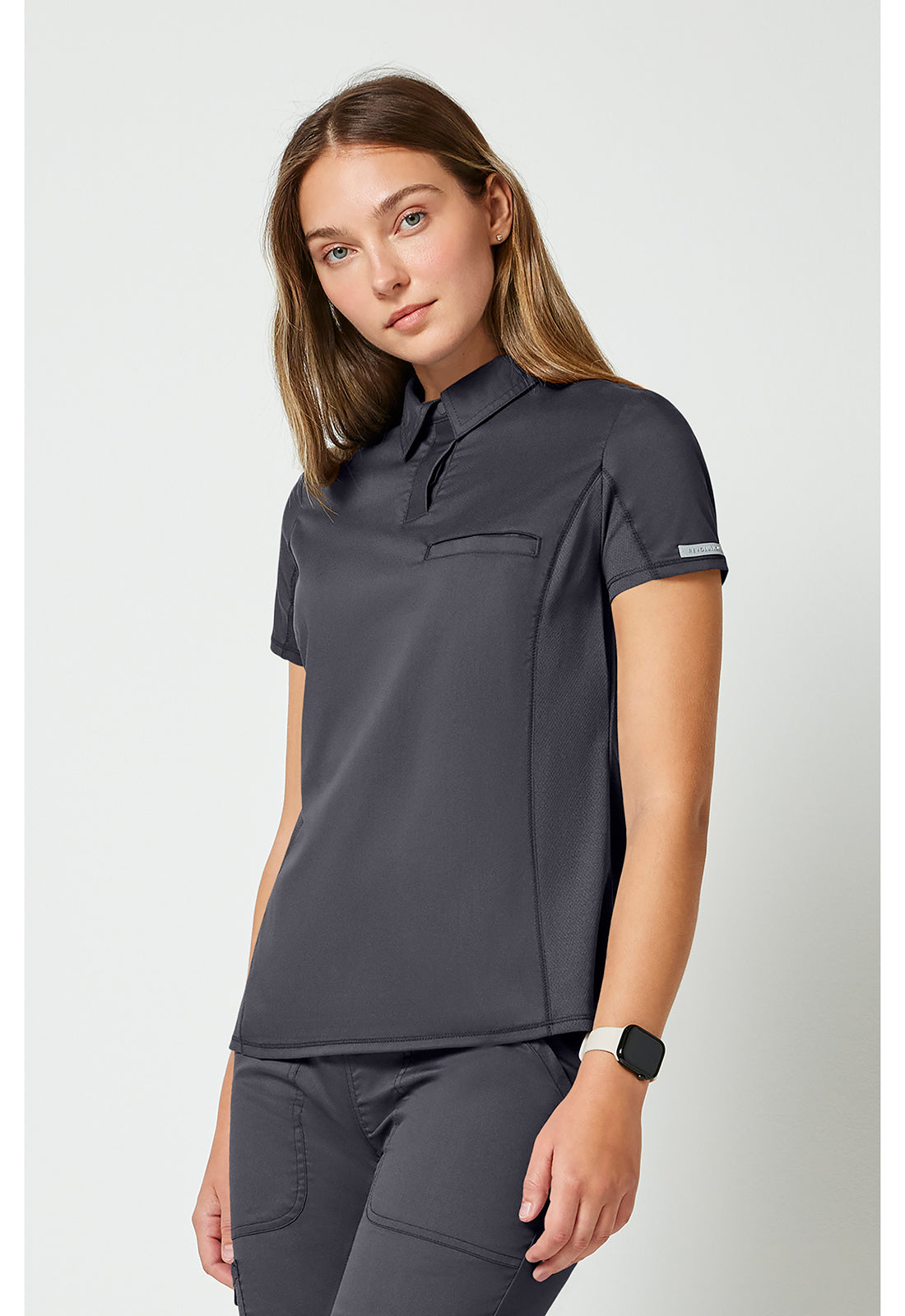 Instopbare polo met drukknoopsluiting aan de voorkant met meshpanelen en 2-way stretch WWE698